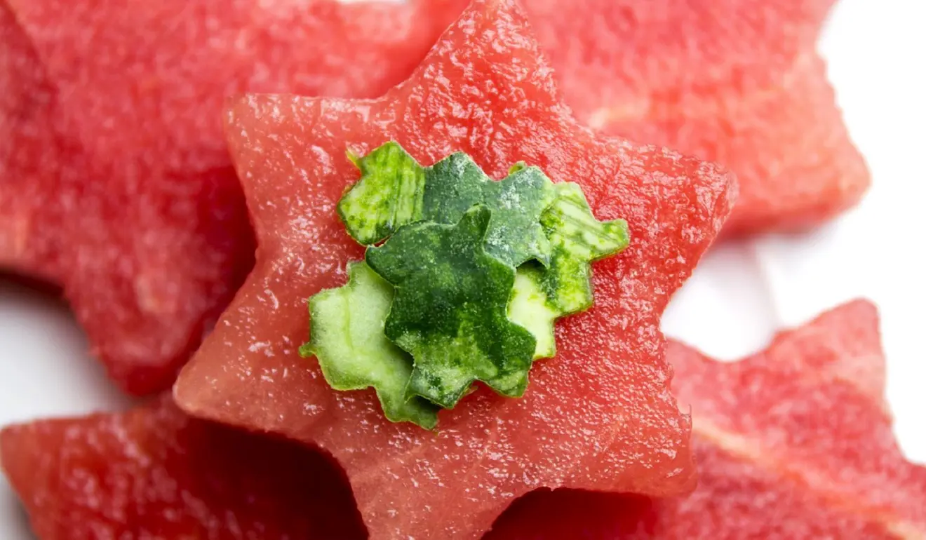 Image of star-shaped slices of watermelon with smaller cut-up bits of skin on top.