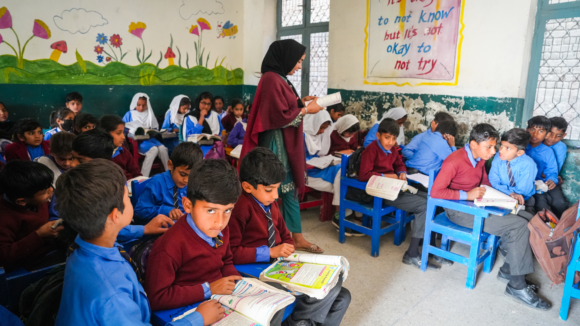 A teacher teaches children in a Muslim Hands' classroom