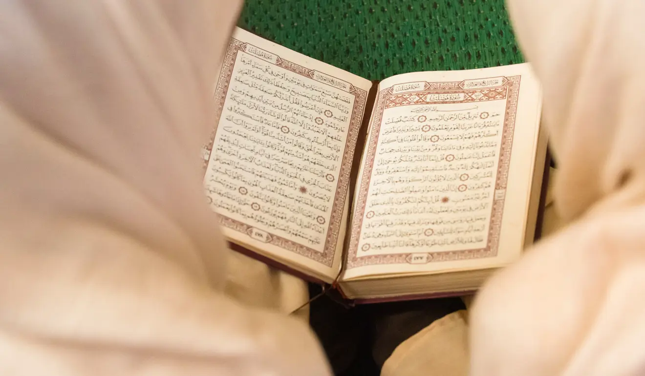 Two girls reciting Qur'an