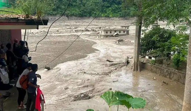 Floodwater gushes down a street in Nepal.