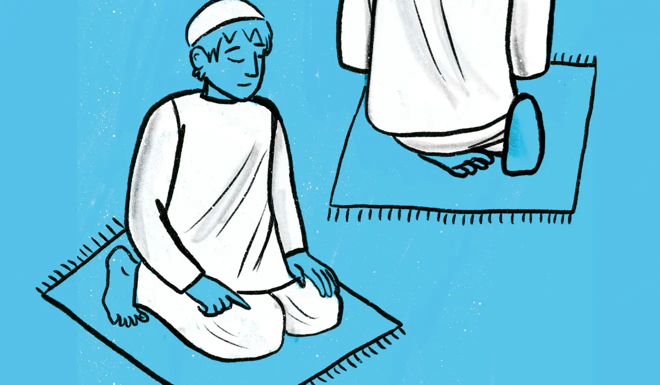 Man in a sitting position on the ground (sitting on his heels) with his index finger pointed outward.